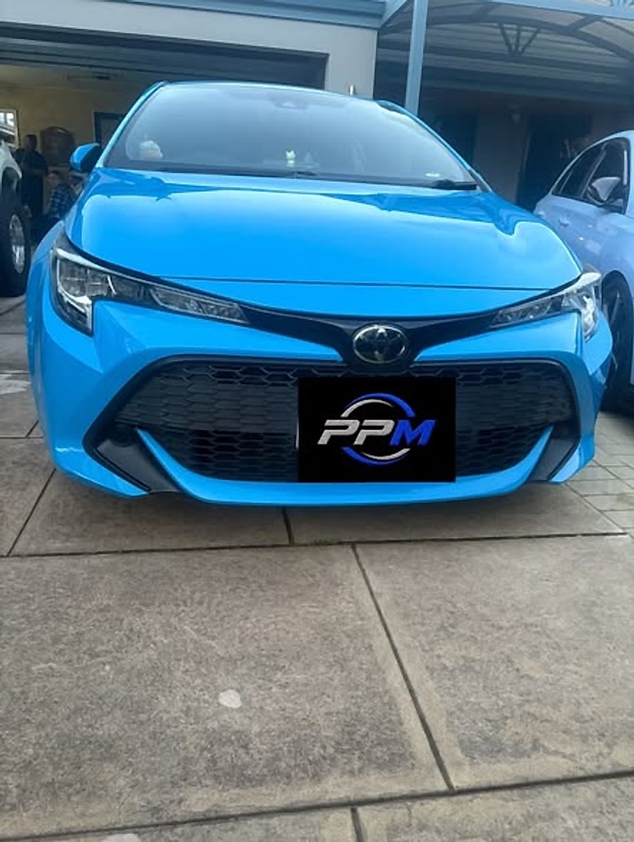 Blue Toyota Corolla hatch parked in a driveway