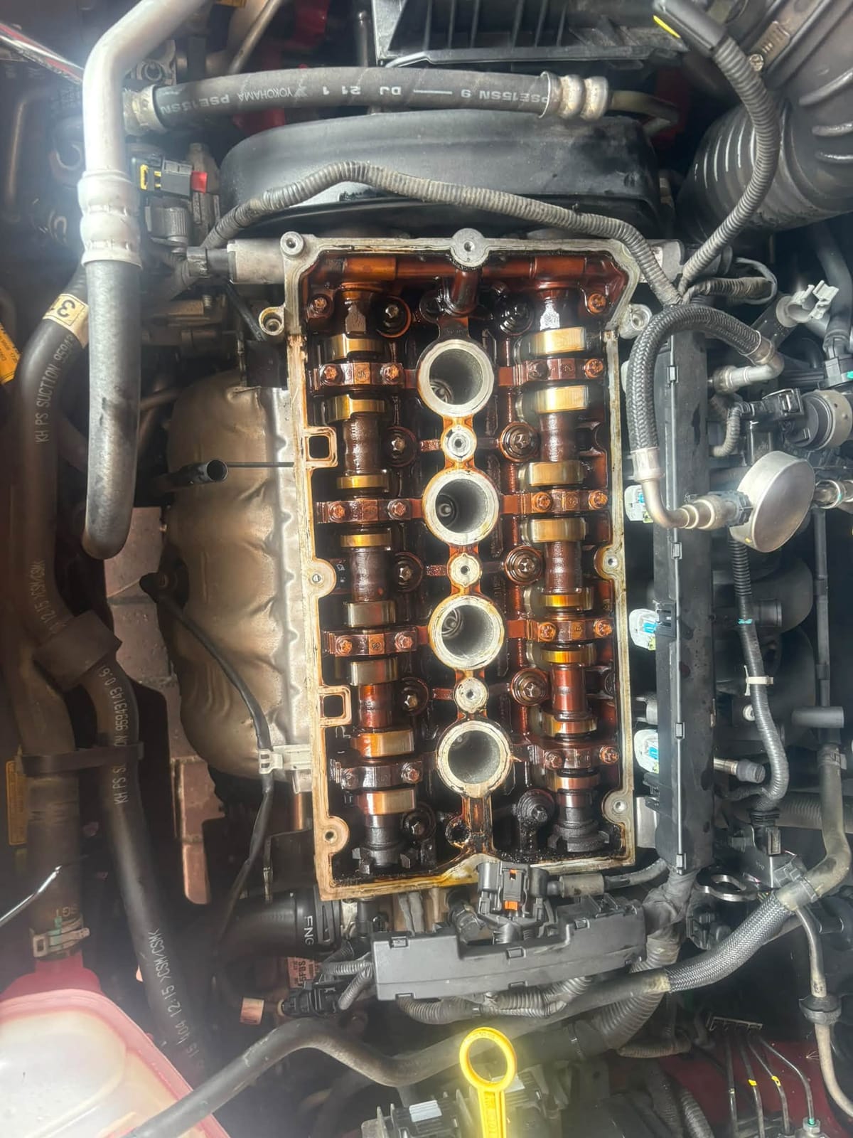 Cylinder head with the engine cover removed, showing the camshafts and spark plug wells