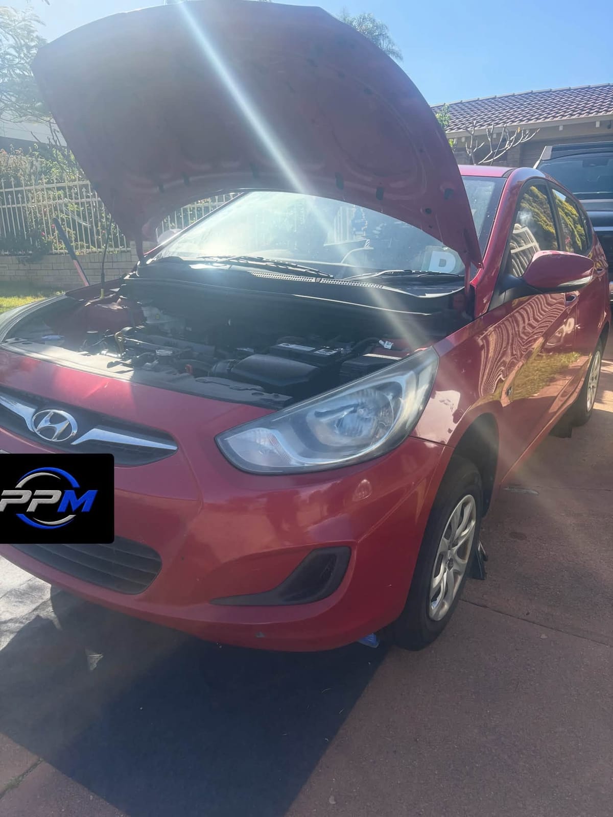 Red Hyundai supported on jacks during the service