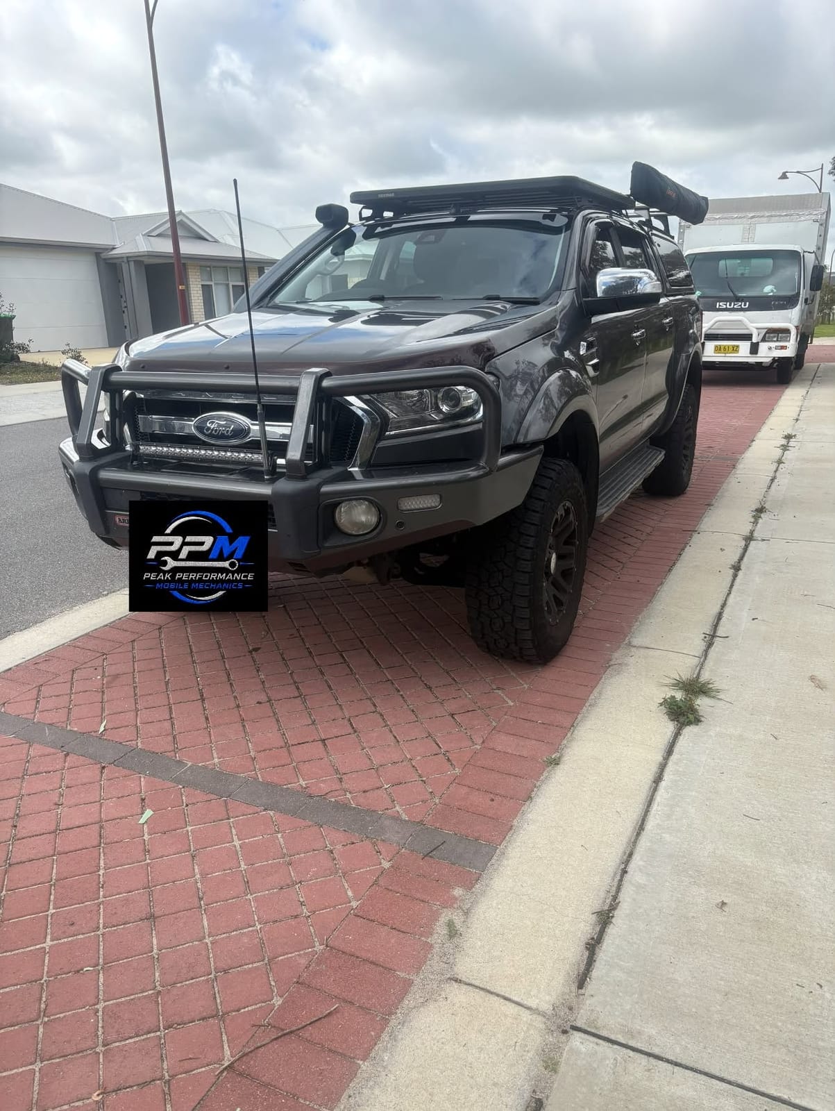 Ford Ranger with bull bar and roof rack with the Peak Performance plate in front