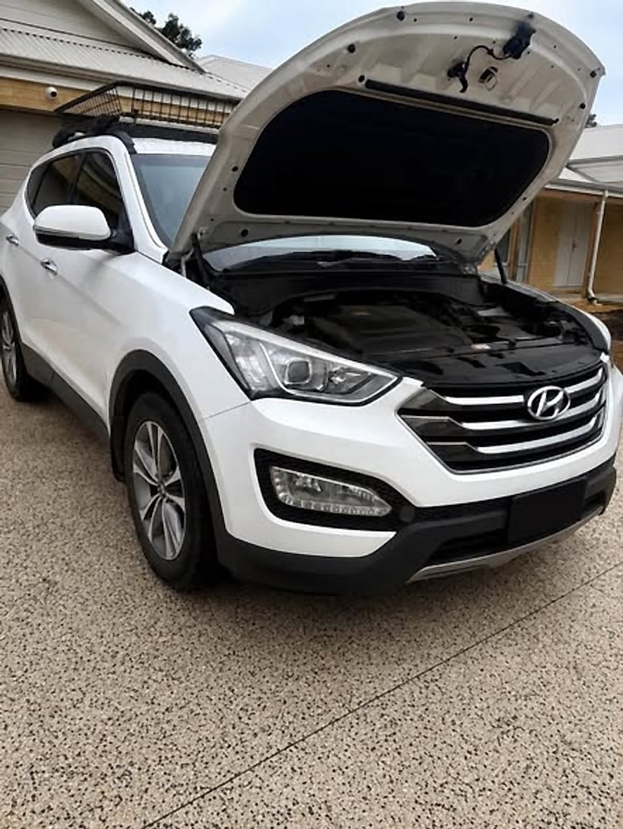 White Hyundai Santa Fe with the bonnet raised in a driveway
