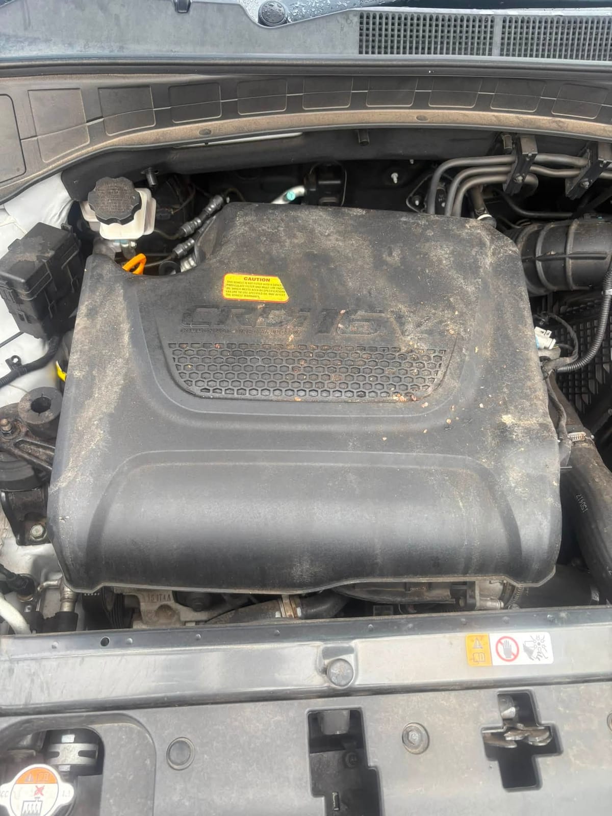 Santa Fe engine cover before, dusty and dirty